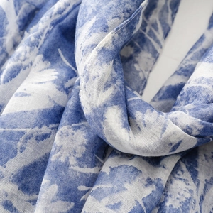 Detail of blue floral print on lightweight cotton-linen shawl with textured fabric