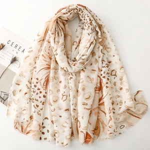 Detail of beige leopard and floral print scarf with soft fringe edges and light fabric