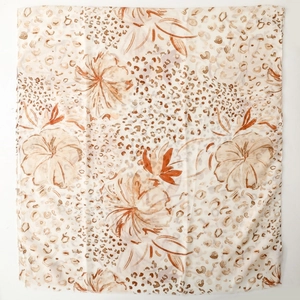 Close-up of floral and leopard print satin scarf with elegant golden foil details