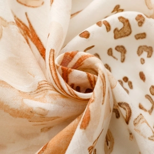Macro view of breathable muslin fabric with classic brown leopard animal print pattern