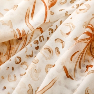 Detail shot of lightweight satin scarf showing leopard print pattern and fabric texture