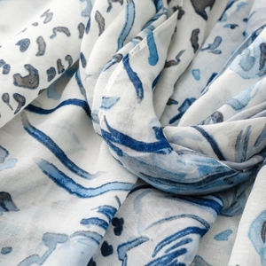 Detail view of lightweight blue leopard floral scarf showing soft draped fabric texture