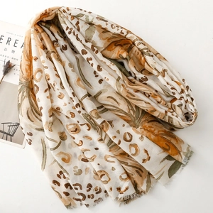 Close-up of leopard and floral print scarf with soft fringe edges and light texture