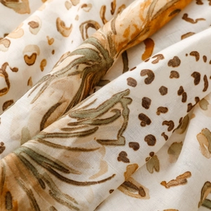 Detail shot of the satin texture and floral leopard print on the lightweight scarf
