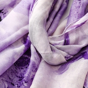Detail of purple gradient iris scarf with elegant gold glitter accents and soft texture
