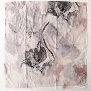 Detailed top view of a lightweight satin scarf with gold foil and ink floral patterns