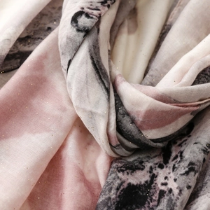 Detailed macro view of iris silk scarf fabric with pink marble ink and gold glitter
