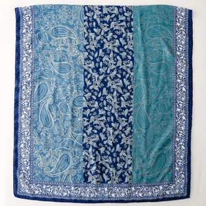 Detail of blue paisley print silk scarf with floral patterns and lace edge detail