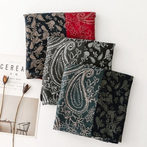 Detail of soft paisley print shawls with floral patchwork and vintage knit texture
