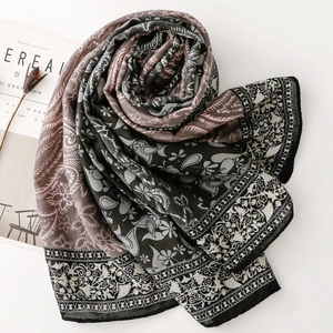 Detailed view of paisley and floral printed scarf with elegant fabric textures and patterns