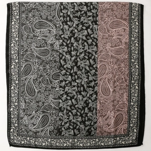 Detail of paisley and floral print on long scarf with vintage grey and pink tones