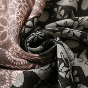 Close-up of paisley floral print fabric showing soft texture and premium draping quality