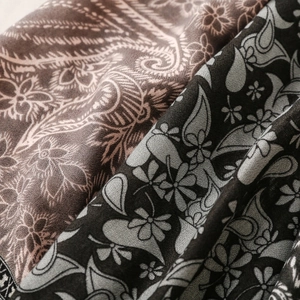 Close-up of elegant paisley pattern and floral texture on soft long scarf fabric
