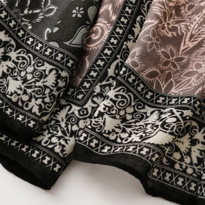 Detailed macro view of Paisley floral print fabric with ethnic geometric border patterns