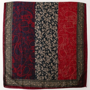 Detail showing paisley and floral prints on a red, black and blue panelled shawl