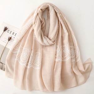 Elegant beige embroidered shawl with white roses on a minimalist textured fabric