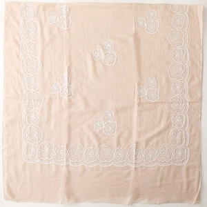 Detailed view of rose embroidery and lace edges on beige ethnic style shawl scarf