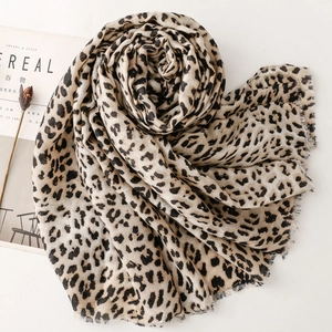 Detailed view of leopard print scarf featuring natural frayed edges and soft cotton linen texture