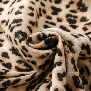 Macro detail of thick satin leopard print scarf showing cotton linen texture