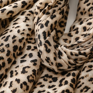 Macro detail of soft cotton linen scarf featuring classic leopard animal print pattern