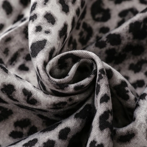Macro shot of grey leopard print scarf showing detailed soft texture and woven edges