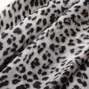 Close-up of lightweight cotton linen leopard print scarf with soft fringe and weave detail