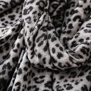 Macro detail of leopard print cotton linen scarf with soft texture and frayed edges