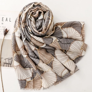 Detail of soft silver ginkgo leaf scarf with gold foil printing and fringe edge