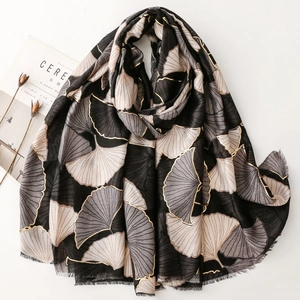 Elegant black cotton linen scarf with gold ginkgo leaf print and delicate fringe edges