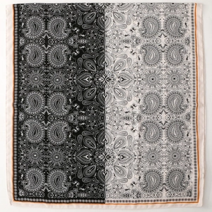 Close-up of black and white paisley floral pattern scarf with refined orange hem edge