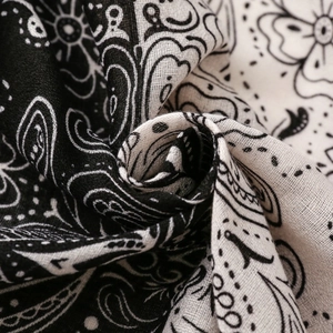 Close-up of lightweight paisley cotton scarf with black and white texture and layered folds