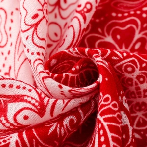 Macro shot of red and white paisley pattern fabric showing soft texture and fine weave