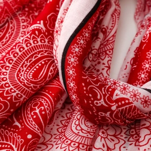Detail of red paisley scarf showing cotton fabric texture and intricate floral pattern