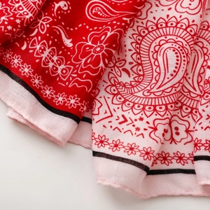 Close-up of red and pink paisley pattern on lightweight cotton linen pashmina scarf