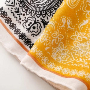 Close-up of paisley pattern scarves showing texture and fine single-sided stitching