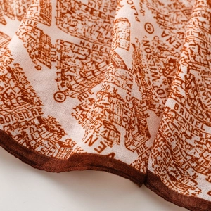 Detailed macro view of vintage map print fabric with refined hand-rolled edges