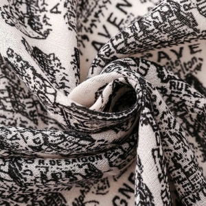 Macro detail of high-quality silk scarf fabric with vintage monochrome print texture