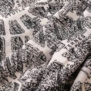 Detail of vintage Paris map print on soft fabric with hand-drawn architectural sketches