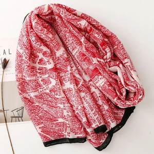 Detail of red and white French map print scarf with black borders and floral accents