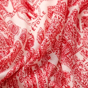 Detailed close-up of lightweight silk scarf with French vintage print and architectural motifs