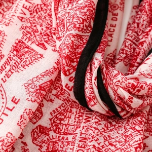 Detailed macro view of red and white French map print scarf with fine black piping
