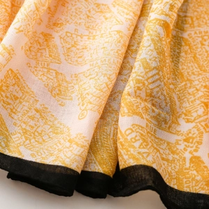 Detail of orange hand-painted floral silk scarf with architectural map print and hem