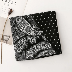 Detail of bicolored scarf featuring Paisley patterns and classic polka dot motifs