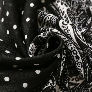 Macro shot of black and white paisley and polka dot printed scarf fabric texture