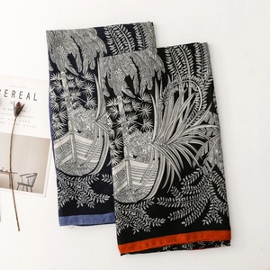 Detail view of tropical floral scarves with palm leaves on white background