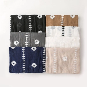 Detailed embroidery on lightweight cotton linen shawls in six elegant solid colors