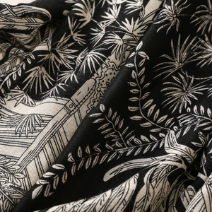 Macro detail of scarf featuring tropical palm leaves and architectural line prints
