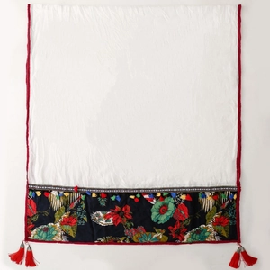 Ethnic white shawl with vintage floral print and tassels in a flat lay view
