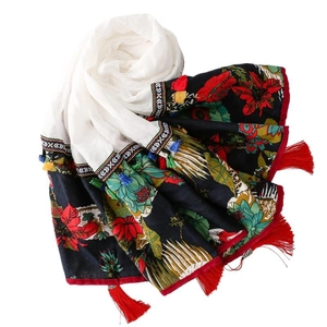 Ethnic embroidered white shawl with red floral patterns and tassel fringe details