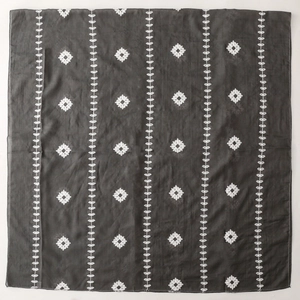 Detailed view of white leaf embroidery on dark grey ethnic style scarf and shawl